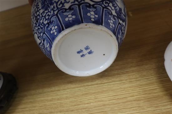 A Chinese blue and white jardiniere, Kangxi mark, and a similar vase, 20.5cm with hardwood stand